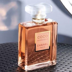Chanel perfume bottle on a textured surface with blurred background
Chanel Coco Mademoiselle Eau de Toilette' is a modern classic —an elegant blend of fresh citrus, delicate florals, and warm oriental notes. This 100% authentic tester perfume delivers luxury and lasting power at a fraction of the retail price.