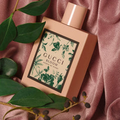 Gucci Bloom perfume bottle with green leafy branches on a pink fabric background
Gucci Bloom Acqua di Fiori Eau de Toilette is a vibrant twist on the classic Bloom, blending green galbanum and sparkling citrus with delicate white florals. It’s a fragrance that evokes springtime, spontaneity, and feminine vitality. This 100% authentic imported tester brings luxury within reach, perfect for everyday elegance.