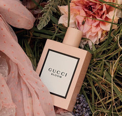 Gucci Bloom perfume bottle on grass with flowers and fabric
Gucci Bloom Eau de Parfum is an enchanting celebration of white florals, created for the modern woman who flourishes in her own authenticity. Rich, radiant, and irresistibly luxurious, this 100% authentic imported tester delivers the elegance of Gucci without the designer price tag.