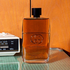 Gucci Guilty perfume bottle on a reflective surface with a vintage radio in the background.
Gucci Guilty Absolute Pour Homme Eau de Parfum is a daring blend of leather and woods, crafted for the man who walks his own path. Deep, dry, and undeniably masculine, it offers a distinctive twist on classic notes. This 100% authentic imported tester delivers Gucci’s unmistakable luxury at a price that won’t hold you back.