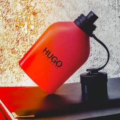 Red water bottle with 'HUGO' branding on a textured wall background, featuring the 'Shappi' brand.
Hugo Boss Red Eau de Toilette is a bold and spicy fragrance crafted for the man who thrives on energy and innovation. With a blend of vibrant citrus, unique metallic notes, and warm base accords, this scent is both intense and magnetic. This 100% authentic imported tester delivers performance, projection, and masculine allure without the premium price tag.