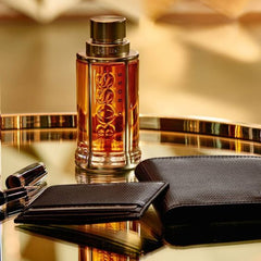 Boss perfume bottle with a black wallet on a reflective surface
Hugo Boss The Scent Eau de Toilette is a bold and captivating composition that blends spicy freshness with rich, masculine warmth. Designed for the modern man who knows the power of attraction, this 100% authentic imported tester delivers luxury, intensity, and sophistication without the premium price tag.