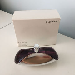 Calvin Klein Euphoria perfume bottle and packaging on a light surface.
Liquid Gold Euphoria Eau de Parfum by Calvin Klein is an enchanting blend of warm spices, floral richness, and creamy woods. Deeply alluring and opulent, it's crafted for those who love bold elegance. This 100% authentic imported tester delivers iconic Calvin Klein sophistication without the luxury price tag.