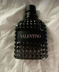 Black perfume bottle with diamond pattern on a white fabric background
Valentino Uomo Born in Roma Eau de Toilette captures the essence of modern masculinity with a vibrant burst of violet leaf, blending it with timeless elegance and a smoky, earthy finish. The sophisticated balance of aromatic sage and smoked vetiver gives it a powerful, distinctive character that lingers long after the first spray. This 100% authentic imported tester offers luxury, longevity, and projection at an unbeatable price.