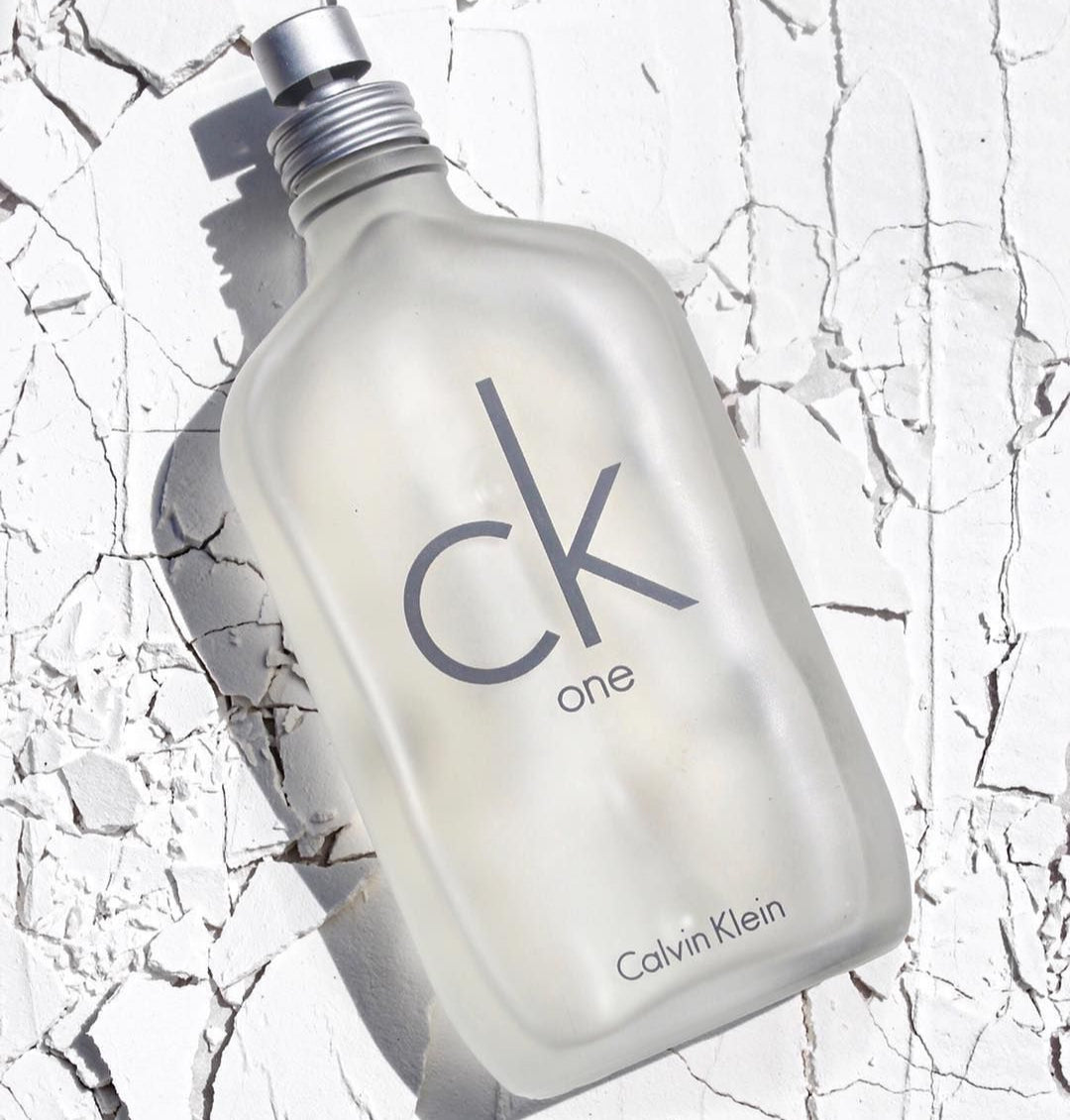 Calvin Klein CK One perfume bottle on a textured white background
CK One Eau de Toilette by Calvin Klein is the ultimate unisex fragrance.&nbsp;A&nbsp;crisp, citrusy blend that’s modern, refreshing, and universally loved. Whether you’re headed to the office, gym, or out on the town, CK One keeps you feeling fresh, light, and energized. This 100% authentic imported tester gives you timeless Calvin Klein quality without the luxury price.