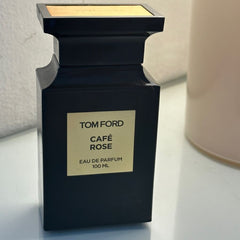 Tom Ford Cafe Rose perfume bottle on a light surface with a neutral background
Café Rose Eau de Parfum by Tom Ford is a seductive exploration of rose layered with exotic spices, dark coffee, and sensual woods. It’s luxurious, deep, and unforgettable&nbsp;crafted for the confident woman who loves to make a statement. This 100% authentic imported tester offers designer quality without the designer price tag.