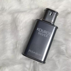 Yves Saint Laurent Kouros Silver perfume bottle on a white fur background
Kouros Silver Eau de Toilette by Yves Saint Laurent is a dynamic reinterpretation of a classic scent. It opens with vibrant fruity freshness, evolves into aromatic elegance, and settles into a warm, woody base. Crafted for the confident and contemporary man, this 100% authentic imported tester offers legendary YSL quality without the designer markup.