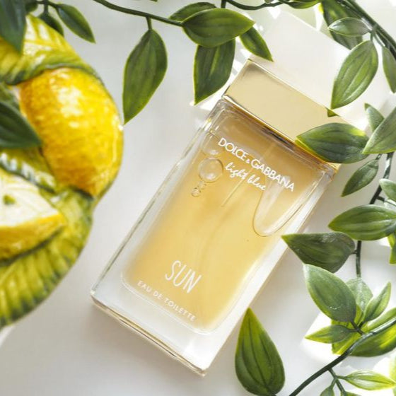 Dolce & Gabbana Light Blue Sun perfume bottle with lemons and green leaves on a white background
Light Blue Sun Eau de Toilette by Dolce &amp; Gabbana is a sparkling and sensual escape to the Mediterranean. With juicy fruits, floral elegance, and creamy coconut warmth, it’s the perfect scent for those who radiate joy, freshness, and effortless charm. This 100% authentic imported tester brings iconic D&amp;G brightness without the luxury price tag.