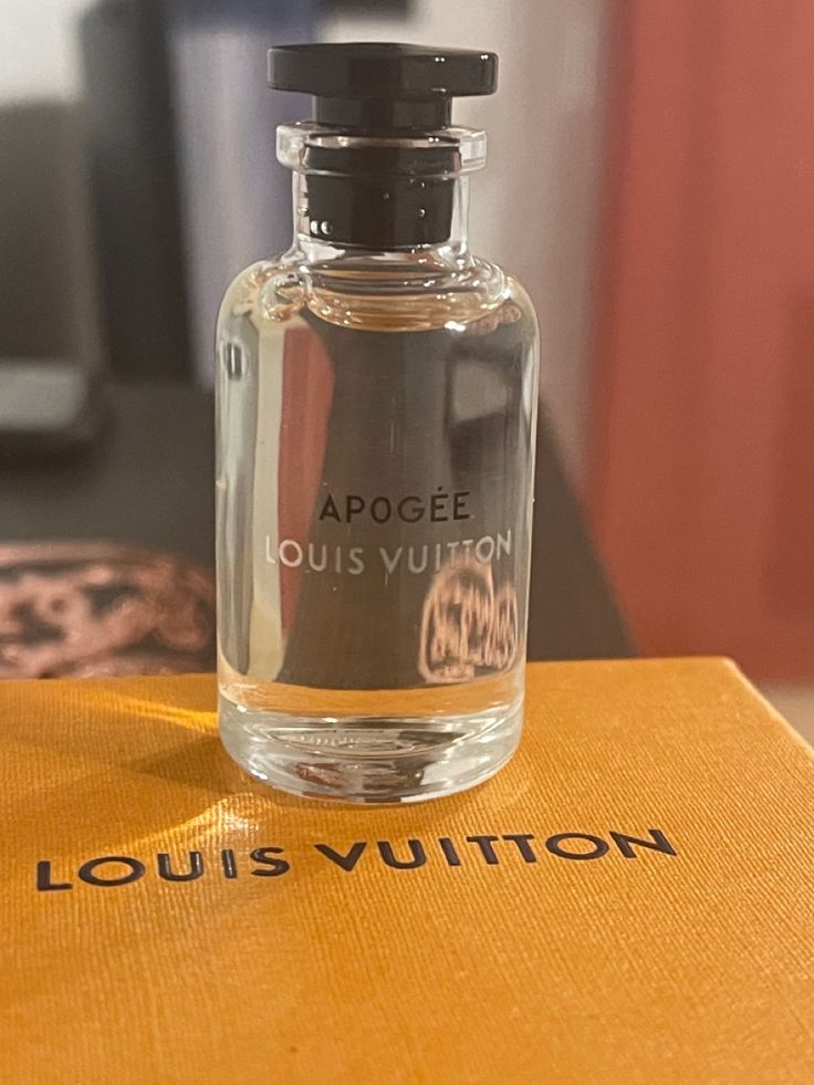 Louis Vuitton perfume bottle on a Louis Vuitton box with a blurred background
Louis Vuitton Apogée Eau de Parfum is a graceful and luminous scent that captures the essence of blooming florals in springtime. With fresh citrus top notes of Tangerine and Orange, a floral heart of Lily-of-the-Valley, Magnolia, Rose, and Jasmine, base of White Musk, Guaiac Wood, and Sandalwood this perfume embodies effortless sophistication and charm. This 100% authentic, imported tester offers luxurious quality, strong perfume