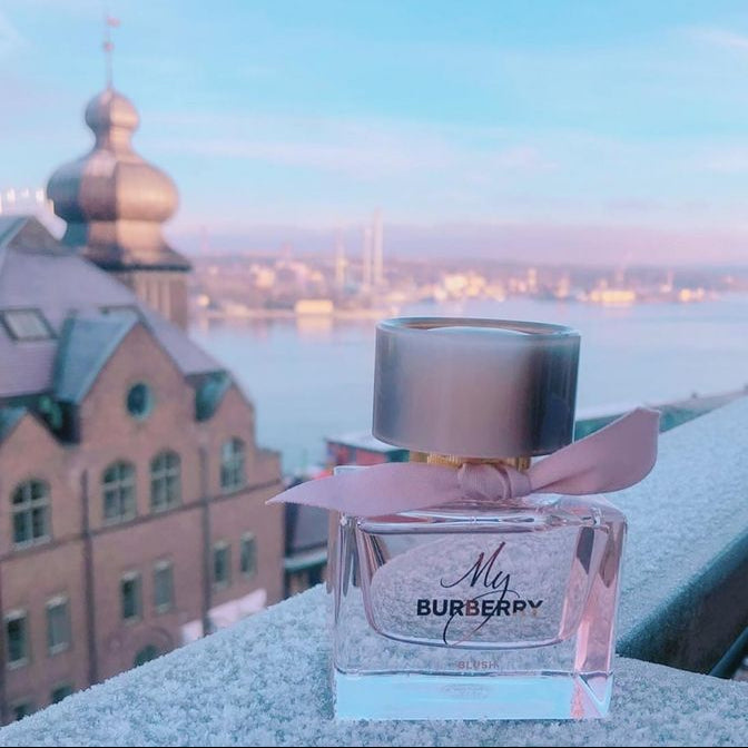 Burberry perfume bottle with a scenic city view in the background
My Burberry Blush Eau de Parfum is a lively and uplifting blend of fruity freshness and delicate florals, inspired by a London garden in the early morning light. Bright and radiant, it’s designed for the woman who radiates optimism and grace. This 100% authentic imported tester brings Burberry’s signature sophistication at an unbeatable value.