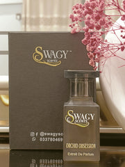 Orchid Obsession Eau de Parfum by Swagy Scents is an alluring blend of exotic orchids, rich florals, and creamy vanilla, elevated with vibrant fruits and warm spices. Feminine yet bold, this 100% authentic imported tester is crafted for those who crave sophistication with a hint of mystery.