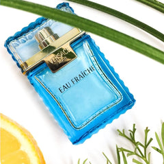 Blue Versace Eau Fraçèche perfume bottle with gold cap on a white background with green leaves.
Versace Man Eau Fraîche is a refreshing take on modern masculinity, cool, clean, and charismatic. Blending crisp citrus, aromatic herbs, and deep woody notes, this scent is designed for the man who is effortlessly stylish and refined. This 100% authentic imported tester offers luxury performance without the premium price.